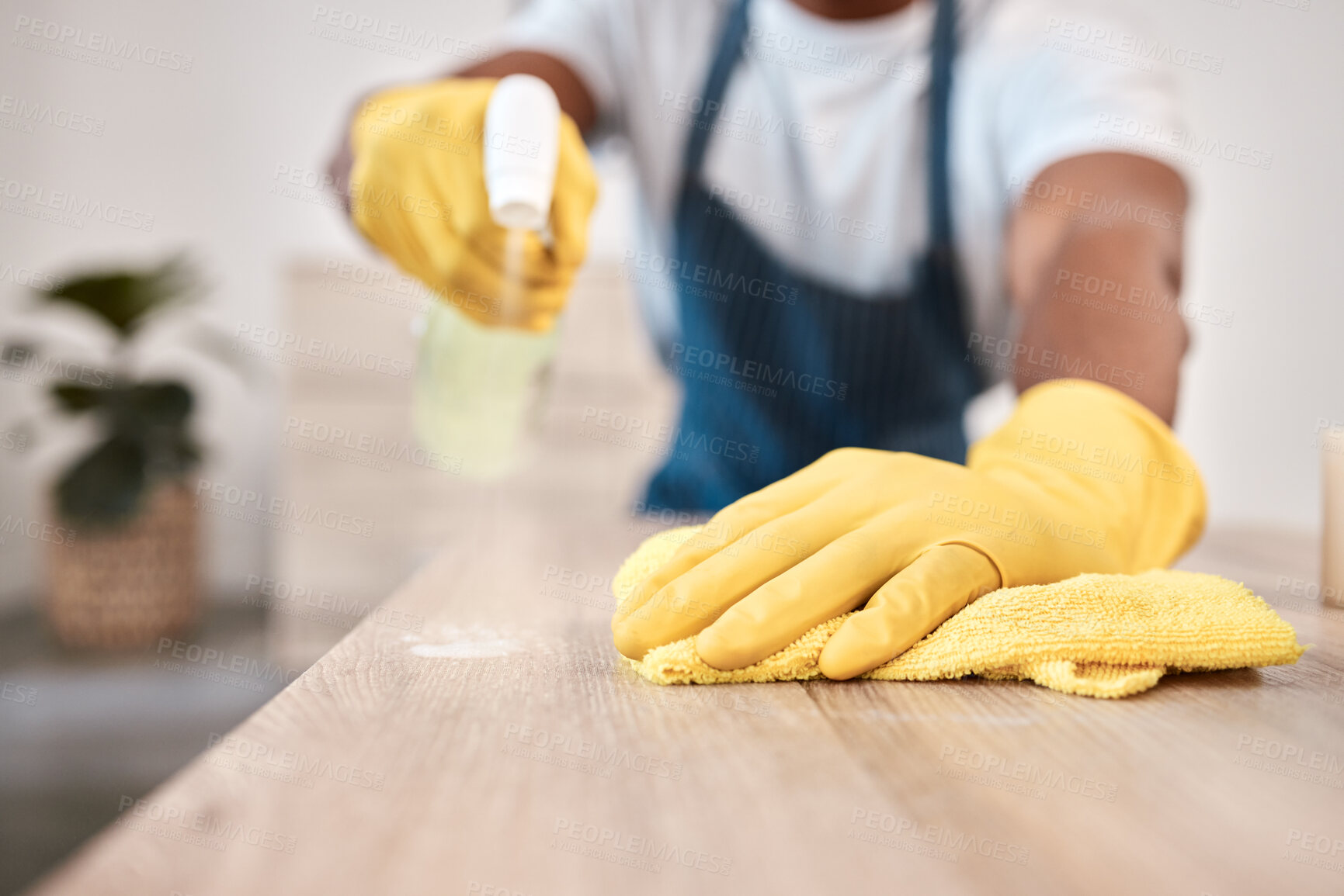 Buy stock photo Black man, hands and spray bottle and cleaning cloth on house table, home desk or office building counter top. Zoom, gloves and fabric bacteria product for hygiene maintenance and healthcare wellness