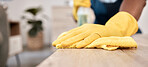 Wiping, cloth and hands of a man on a table cleaning the dust with gloves in a house. Bacteria, service and cleaner with product to clean for disinfection of a surface, desk or apartment for health