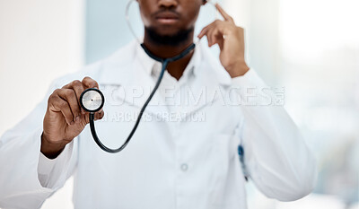 Black man doctor, stethoscope and health with medical examination and check up in hospital. Healthcare, health insurance and professional in medicine, surgeon listening to heartbeat with white coat.