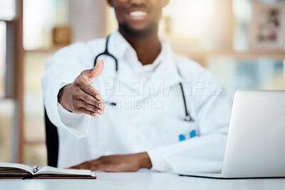 Buy stock photo Doctor, laptop and greeting, welcome or handshake in hospital, office or clinic. Shaking hands, helping hand and black medical physician offering help, assistance or onboarding, deal and thank you.

