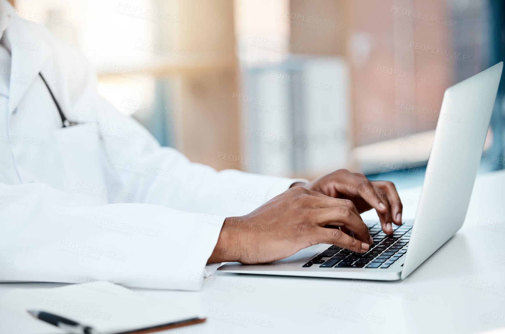 Buy stock photo Doctor, hands and typing on laptop in office, working on research or online consultation. Healthcare, computer and black male physician writing patient report, data record or checking medical email.