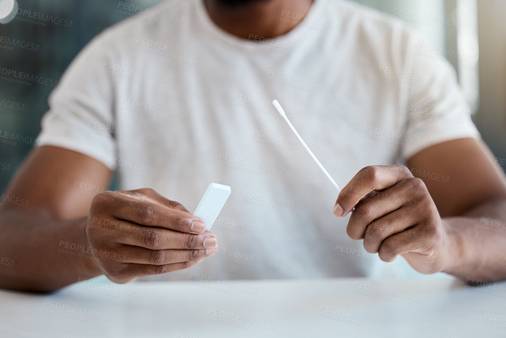 Buy stock photo Covid, test and hands of a man with a medical kit for healthcare and safety from a virus at a table in a hospital. Corona, health care and sick person with results from a pcr sample at a clinic