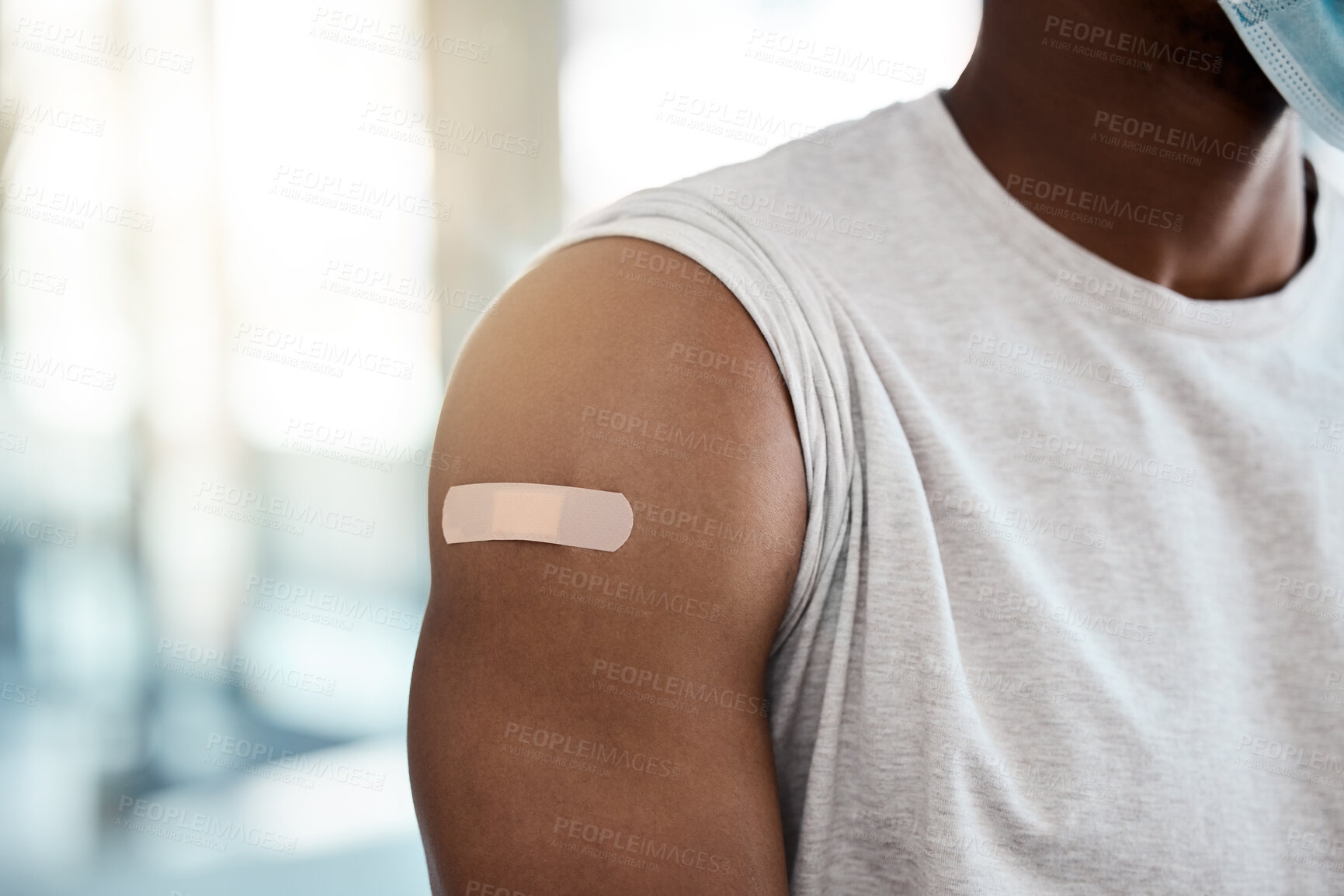 Buy stock photo Black man, covid vaccine and plaster on arm for safety, healthcare and prevention or government compliance for health and wellness. Bandaid, first aid and patient injection for covid 19 virus