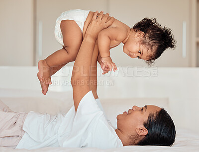 Buy stock photo Love, mother and baby in the air in bedroom, being playful and bonding together in home. Mama, toddler and child playing on bed, being loving and connect for quality time, happiness and have fun.