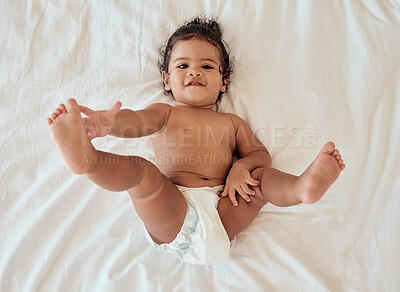 Buy stock photo Happy, smile and portrait of a baby with a diaper relaxing on a bed in his bedroom or nursery. Happiness, health and toddler kid by with a disposable nappy laying and relaxing in room at family home.
