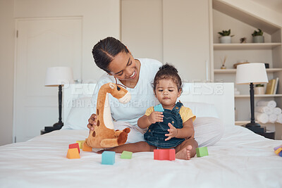 Buy stock photo Mother, baby and toys for learning, education and development with building blocks and teddy bear on a bed in a home bedroom. Woman and child together for bonding, love and support while playing