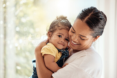 Buy stock photo Family, love and care with a hug, love and support of mother for baby while together at home for quality time, bonding and happiness. Woman carrying child for security and safety in their family home