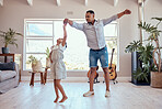 Father, daughter and dancing in living room family home with energy, freedom and fun, relax and happy lifestyle together. Dad, girl kid and happy family spinning dance to music, bonding and happiness