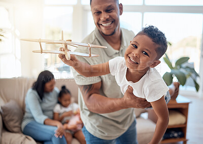 Buy stock photo Dad, boy and toy plane in living room for game, fun or bonding while happy together. Father, son and play airplane toys with smile at house with love, happiness or family home  lounge in Orlando