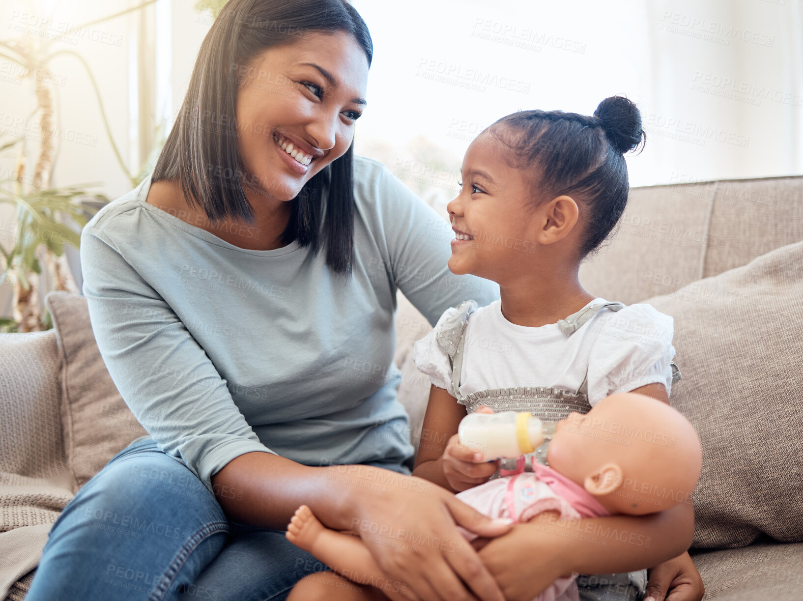 Buy stock photo Home, mother and child with doll playing on sofa having fun, bonding and enjoying weekend. Family, love and mom sitting with young girl with toys on couch for quality time, holiday and happy together