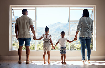 Buy stock photo Love, back view and family holding hands by window looking at scenic view of nature, trees and mountain. Bonding, affection and mom and dad standing with kids in new apartment, happy in family home