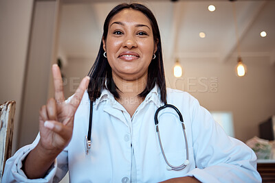 Buy stock photo Doctor, black woman and peace sign in video call, hospital and smile with happiness, proud and medical job. Woman, nurse or happy medic in clinic, office or telehealth in healthcare with hand signal