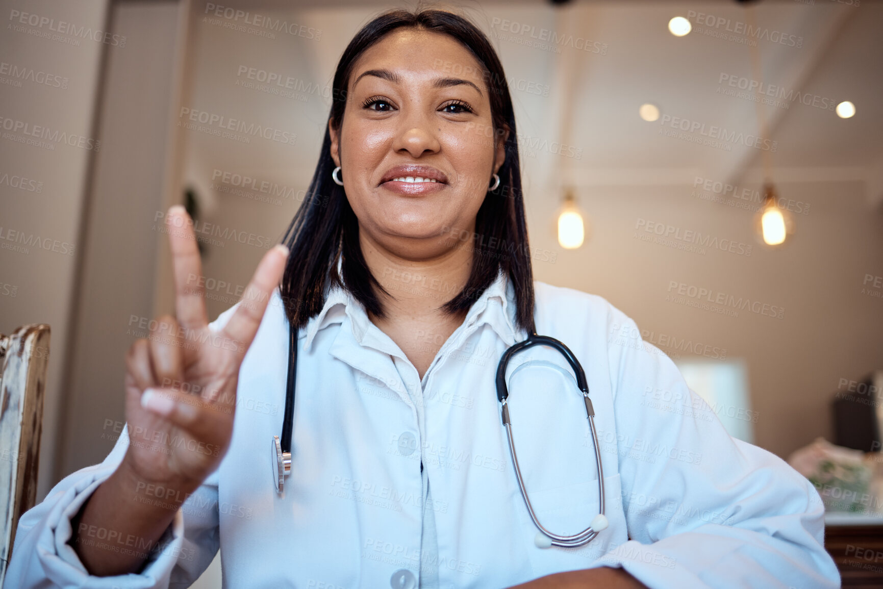 Buy stock photo Doctor, black woman and peace sign in video call, hospital and smile with happiness, proud and medical job. Woman, nurse or happy medic in clinic, office or telehealth in healthcare with hand signal