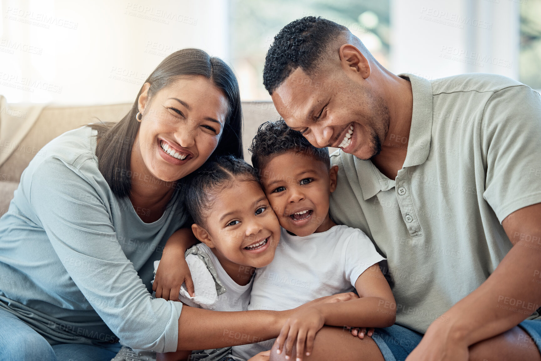 Buy stock photo Happy, love and family portrait with kids, parents and relax on a sofa with a smile in the living room. Happiness, care and mom with dad sitting and holding children with joy on a couch in home.