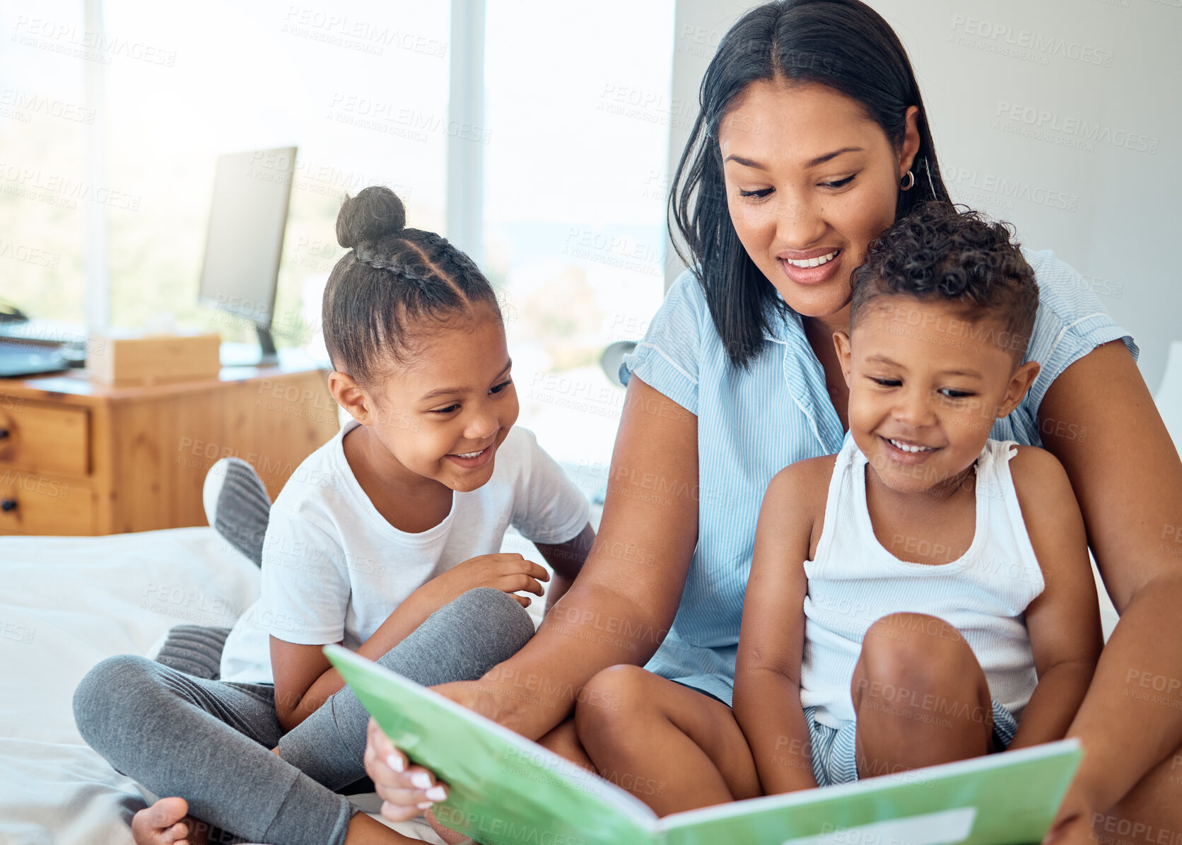 Buy stock photo Mother reading a book to her children in a bedroom to relax, bond and learn in their family home. Happiness, education and woman doing storytelling with her kids while relaxing on a bed in a house.