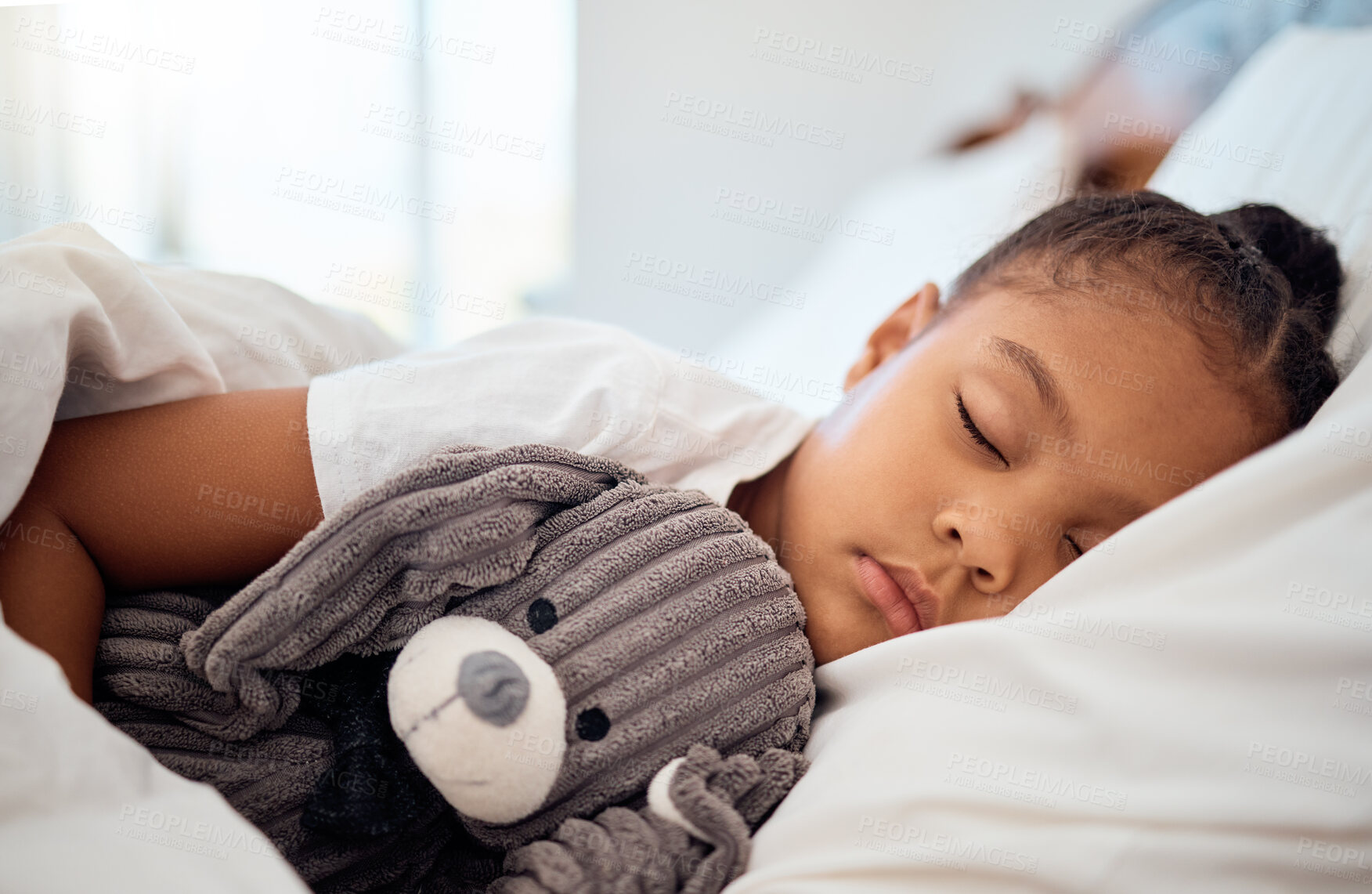 Buy stock photo Peace, morning and wellness of black child sleeping in cozy bed with toy teddy in home on the weekend. Relax, sleep and health of kid dreaming in comfortable home bedroom with teddy bear.

