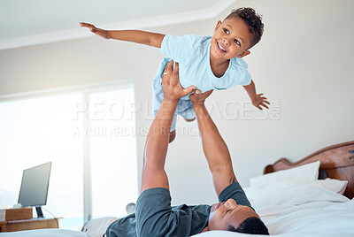 Buy stock photo Father lifting kid in air in the bedroom having fun, playing and enjoying morning together. Bonding, love and dad holding young child in bed to pretend to fly for quality time and relax with family