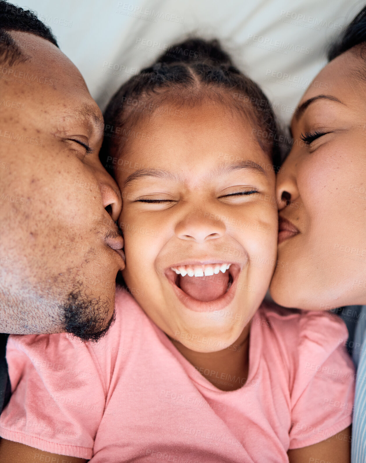 Buy stock photo Top view, mother and father kiss girl on cheeks, bonding and loving in bedroom on weekend together in home. Family, love and parents with daughter, happy and smile for quality time, 