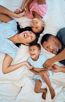 Buy stock photo Happy, fun and family bedroom bed with mother, father and kids laughing in the morning at home. Funny time, love and parents care about children tickle and play together with happiness and bonding