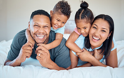 Buy stock photo Happy, love and family with a smile on a bed to relax together in bedroom of their house. Happiness, father and mother laying in the room with children while bonding, relaxing and having fun at home.