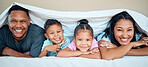 Love, blanket and happy family in bed together for quality time, care and support with smile. Relax, parents and children portrait for relationship bonding happiness lifestyle in family home bedroom
