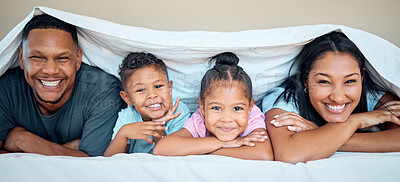 Buy stock photo Love, blanket and happy family in bed together for quality time, care and support with smile. Relax, parents and children portrait for relationship bonding happiness lifestyle in family home bedroom