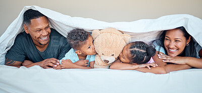 Buy stock photo Black family, bed and teddy bear with parents and kids kissing a stuffed animal while lying together in a bedroom. Portrait, love and children inside to relax in the morning with mother and father
