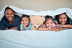 Love, bed and parents with children and teddy bear under the blanket bonding, smiling and enjoying morning. Affection, black family and portrait mom and dad with kids in bedroom laying together