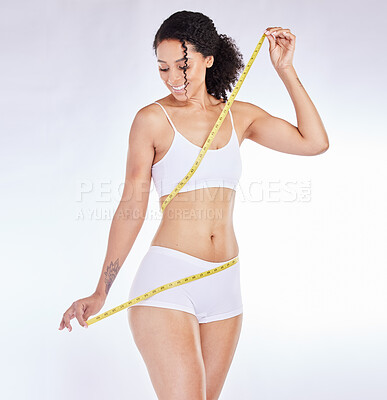 Buy stock photo Black woman, tape measure and smile for weight loss, waist or body care against a gradient background. Happy African American female measuring body for slim healthy diet, wellness or detox on mockup