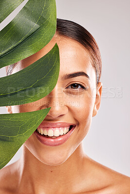 Buy stock photo Leaf, woman and beauty, natural skincare and clean cosmetics for wellness, glow and sustainability on studio background. Portrait of happy model face, green monstera leaves and eco plants dermatology