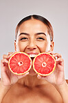 Skincare, beauty and portrait of woman with grapefruit in hands on white background in studio. Wellness, body care and female with fruit for organic, natural and healthy cosmetics and makeup products