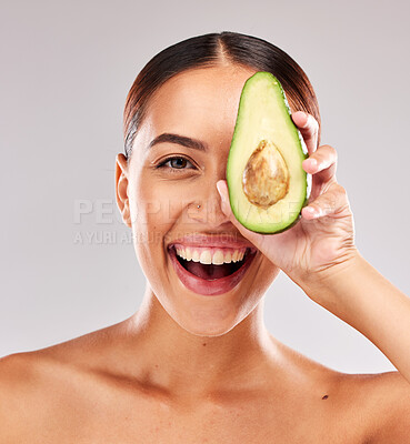 Buy stock photo Avocado, portrait and woman with natural skincare for wellness, beauty and nutrition against a grey studio background. Food, healthcare and excited model with healthy diet for body and lifestyle