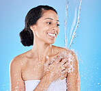 Water splash, beauty and black woman clean, grooming and in shower for hygiene against blue studio background. Water, hydration and skincare, fresh and healthy skin with treatment and cosmetic.