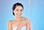 Shower, black woman and water splash, skincare and happy portrait of wellness, hygiene or health in blue studio background. Cleaning, cleansing and bathroom with a attractive young female in bathroom