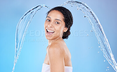 Buy stock photo Water, splash and hygiene with a model black woman in the studio shower on a blue background for hygiene. Portrait, face and water splash with an attractive young female cleaning in the bathroom