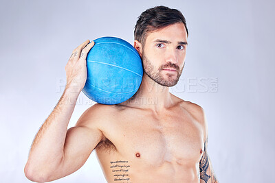 Buy stock photo Health, fitness and medicine ball with a man model in studio on a gray background for exercise or wellness. Portrait, body and training with a handsome young male athlete posing topless for lifestyle