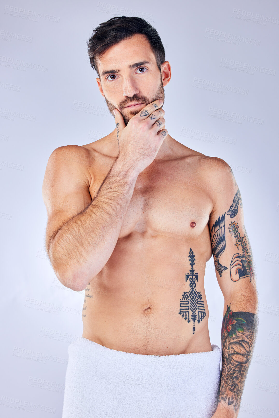 Buy stock photo Man, thinking and tattoo with a towel, shower and sexy against grey studio background with mockup space. Portrait, idea and male model with creative body ink, art and after a bath, clean or beauty