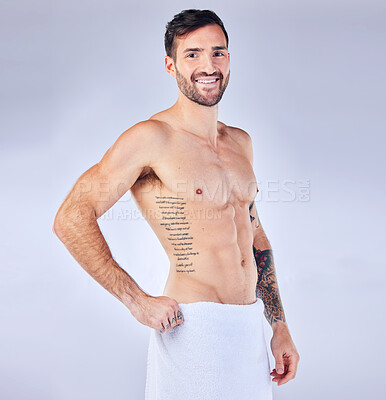 Slim muscular man posing with towel on hips Stock Photo