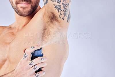 Buy stock photo Health, wellness and man spray deodorant for hygiene, fragrance or fresh scent after shower on studio background mock up. Perfume, product and male model spraying armpit to prevent odor or smell.

