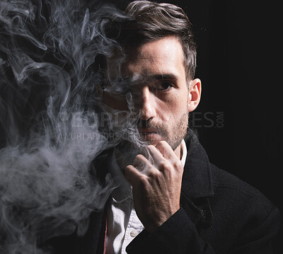 Buy stock photo Face, fashion and smoke with a man portrait in studio on a dark background for trendy style. Cloud, beauty and classy with a handsome male posing for edgy, contemporary clothes on a black background