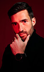 Model, face and portrait of man for beauty, skincare and fashion on a red studio background. Trendy, edgy and stylish man front for cool facial health and wellness on a dark studio background
