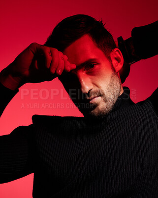 Buy stock photo Art, fashion and portrait of man in red background with serious expression on face in studio. Health, beauty and wellness, designer advertisement, sexy man or male model in red light and sensual look