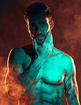 Fitness, tattoo and man in studio for wellness, exercise and body goals with smoke, fire and danger aesthetic. Portrait, sexy and male model with misty atmosphere pose for training, muscle and power