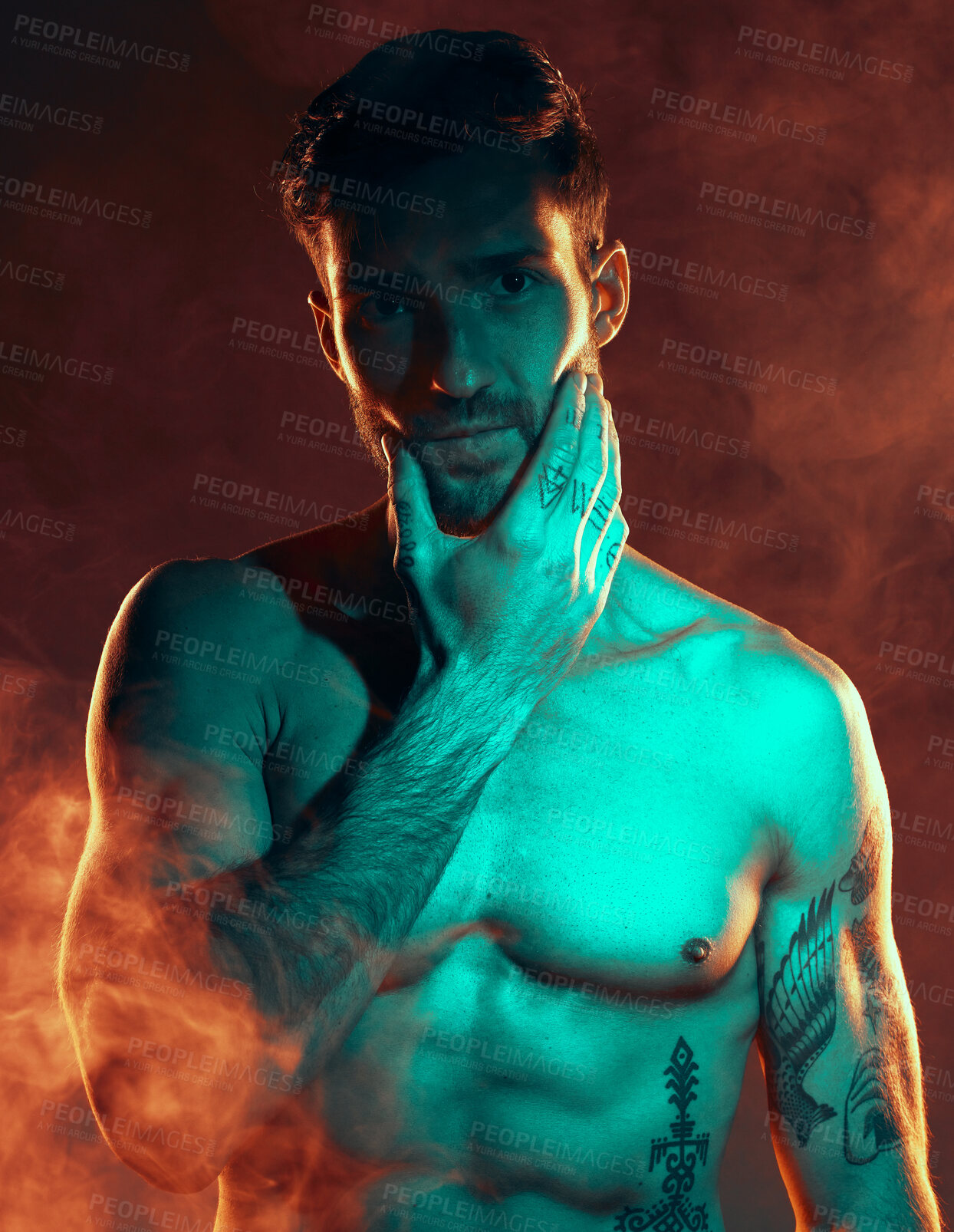Buy stock photo Fitness, tattoo and man in studio for wellness, exercise and body goals with smoke, fire and danger aesthetic. Portrait, sexy and male model with misty atmosphere pose for training, muscle and power