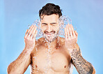 Fitness, skincare and water splash, man on studio background happy and topless with tattoo. Health, wellness and fresh clean water, sport guy with muscles, healthy mindset and body positive lifestyle