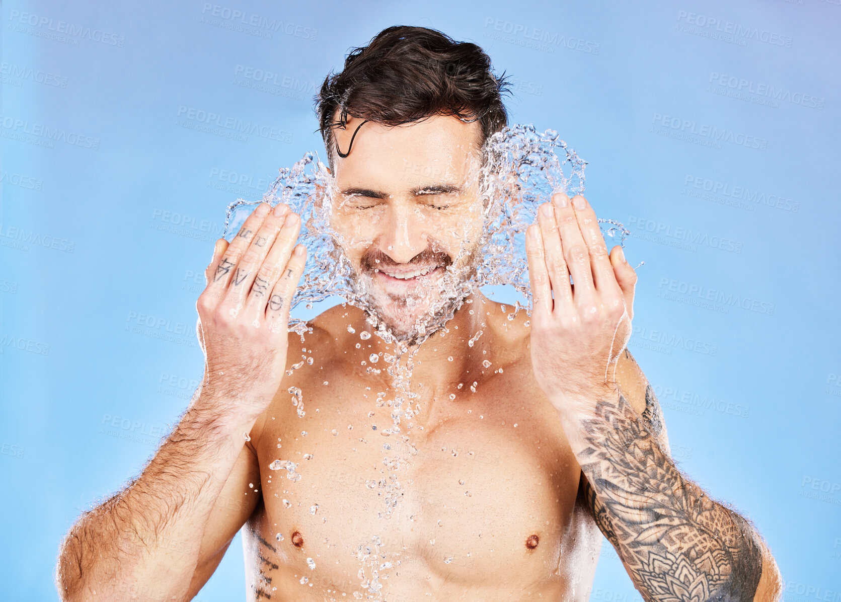 Buy stock photo Health, skincare and water splash, man on studio background happy and topless with tattoo washing face. Smile, wellness and clean water, guy with muscles, healthy mindset and body care lifestyle.