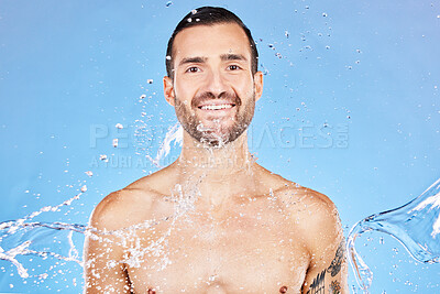 Buy stock photo Skincare, portrait and water splash of man in studio isolated on a blue background. Health, cleaning and male model from Canada bathing and washing for wellness, body care and fresh beauty routine.
