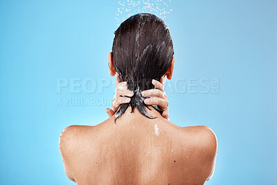 Buy stock photo Back, woman and shower for hygiene, bathroom and freshness on blue studio background. Mockup, female and healthy girl with water, clean and wet for wellness, skincare and health with drops and splash