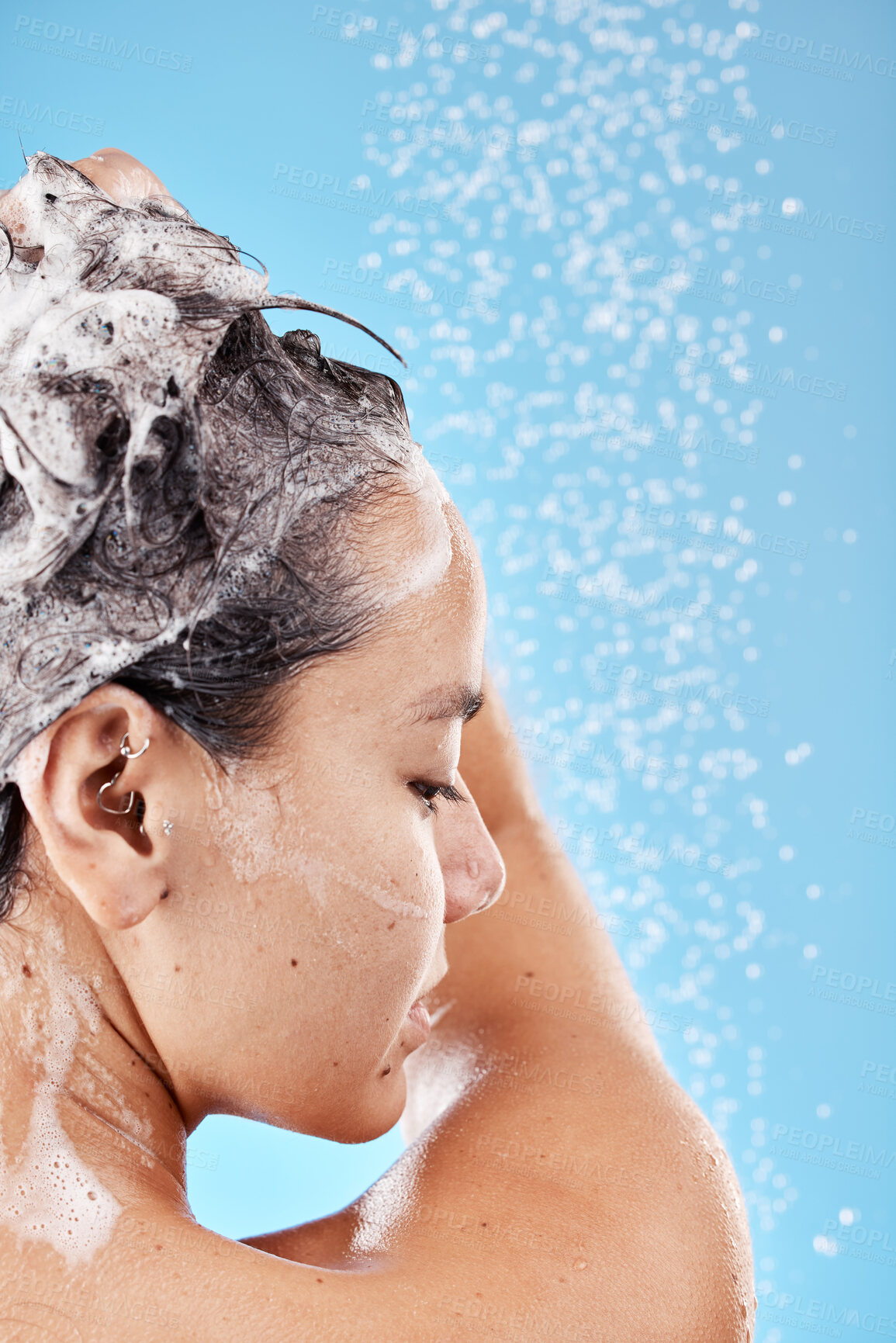 Buy stock photo Beauty, woman in shower and shampoo hair for haircare health, wellness and cosmetics product on blue background. Healthcare, hygiene and body wash with water of studio advertising or marketing mockup