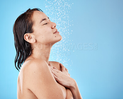 Buy stock photo Asian woman in shower, water on face and skincare beauty with healthy wet hair on blue background. Wellness in studio, washing natural body care in bathroom or hygiene cleaning stream of water drops